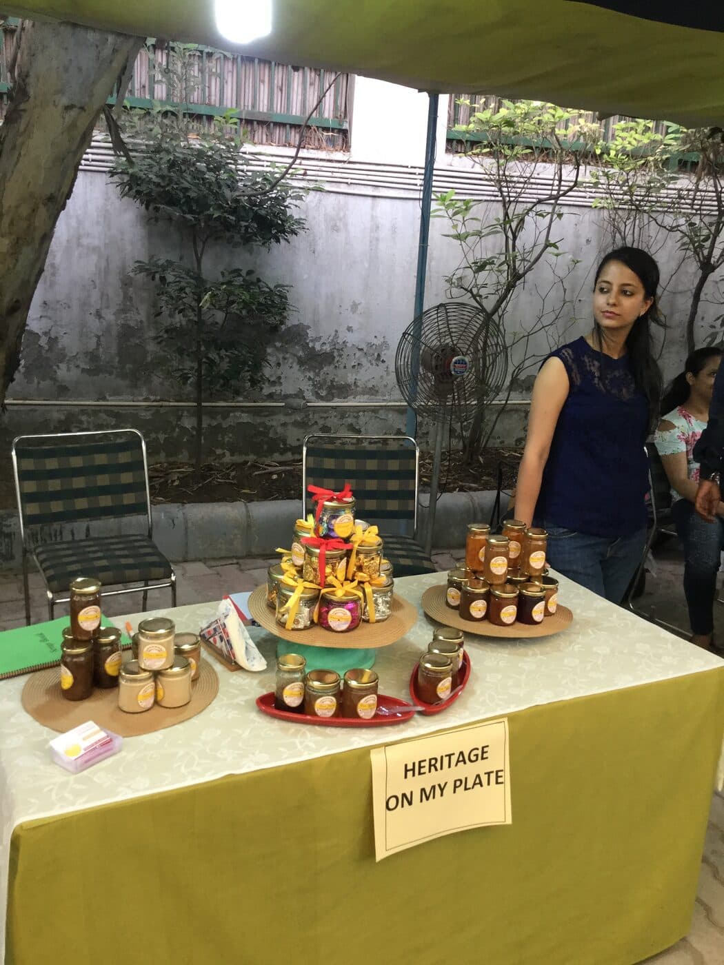 Sanchi beside a tiered display of our jars at an early pop-up stall